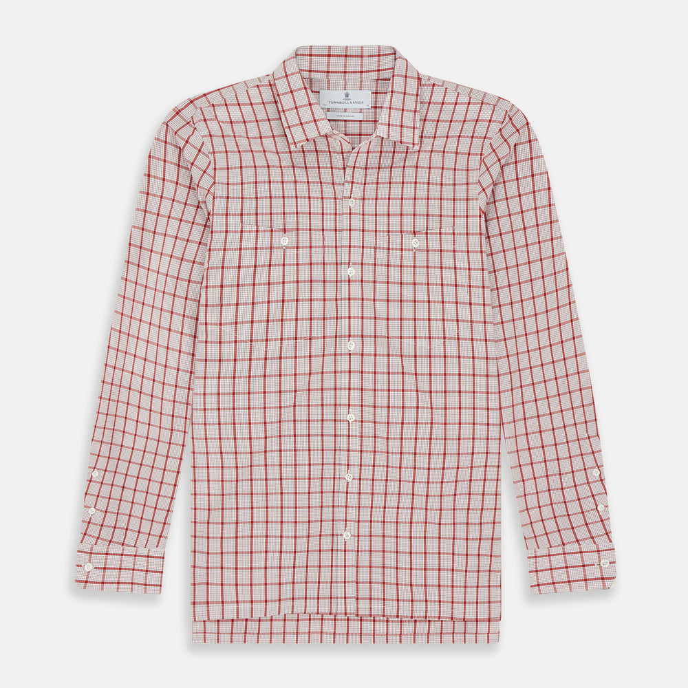 The Turnbull & Asser Red Graph Overlay Check Piccadilly Shirt is a cotton, long-sleeve button-up with a white base, red graph check pattern, collar, two chest flap pockets, and white buttons on the front and cuffs.