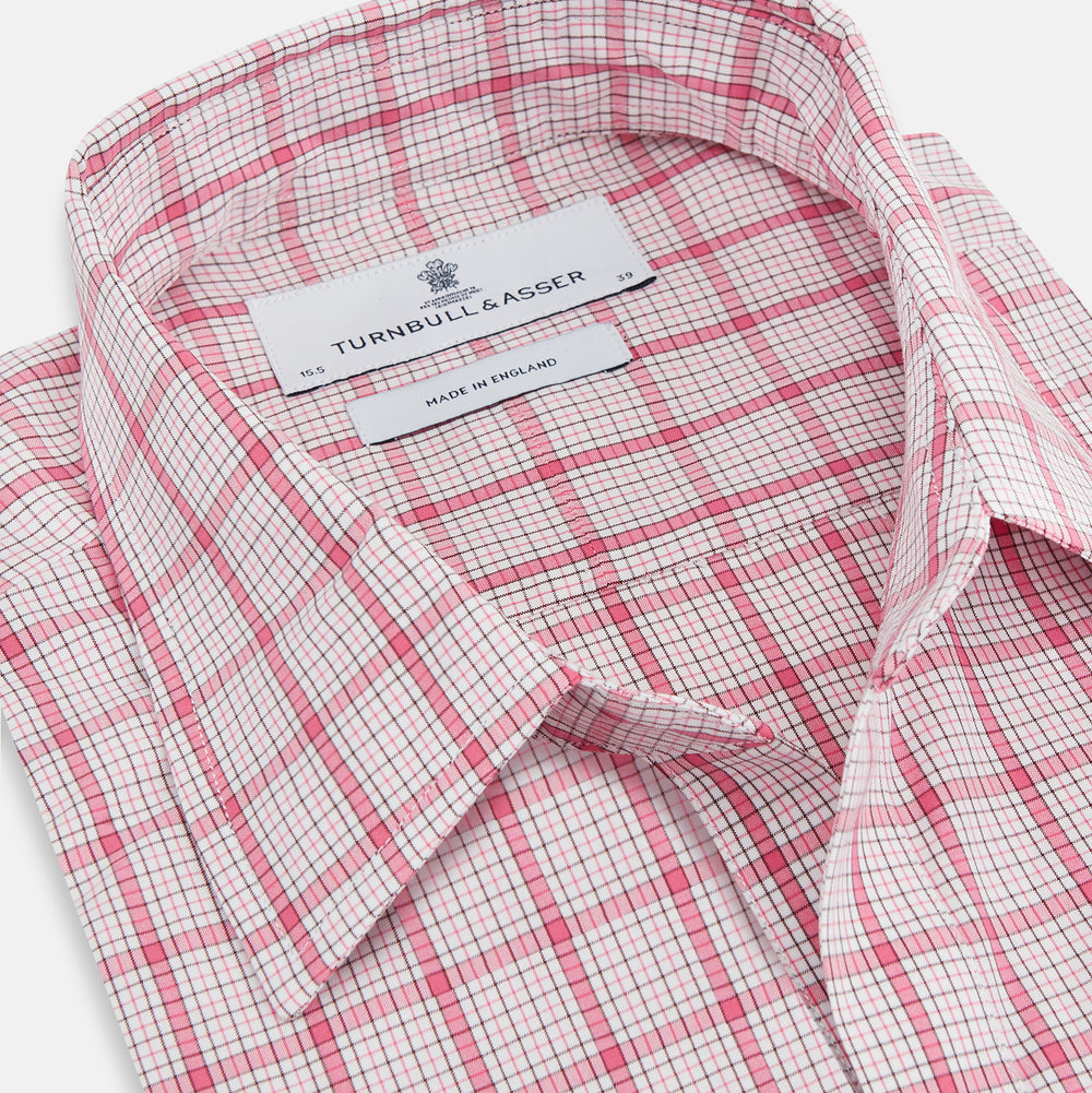 The Pink Graph Overlay Check Piccadilly Shirt by Turnbull & Asser features long sleeves, a button-up front, collar, and chest pockets—a stylish cotton option in a red and white check pattern for the holidays.