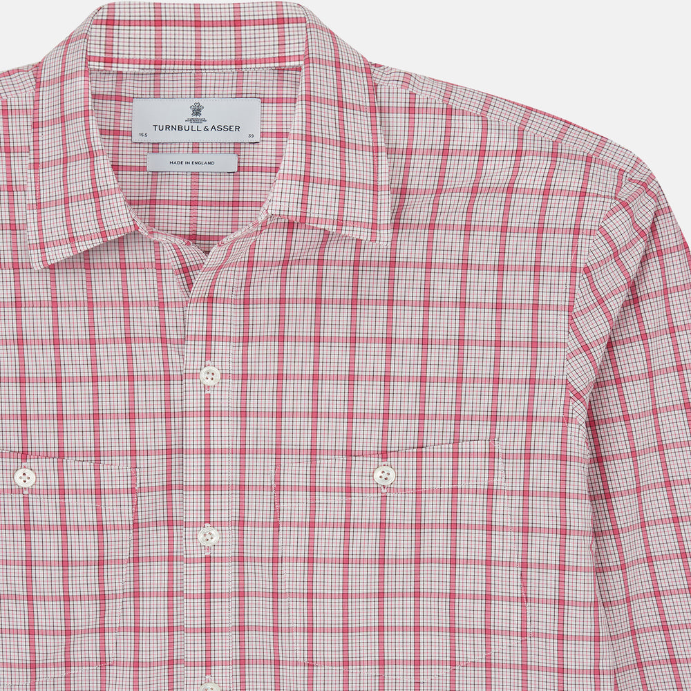 The Pink Graph Overlay Check Piccadilly Shirt by Turnbull & Asser features long sleeves, a button-up front, collar, and chest pockets—a stylish cotton option in a red and white check pattern for the holidays.