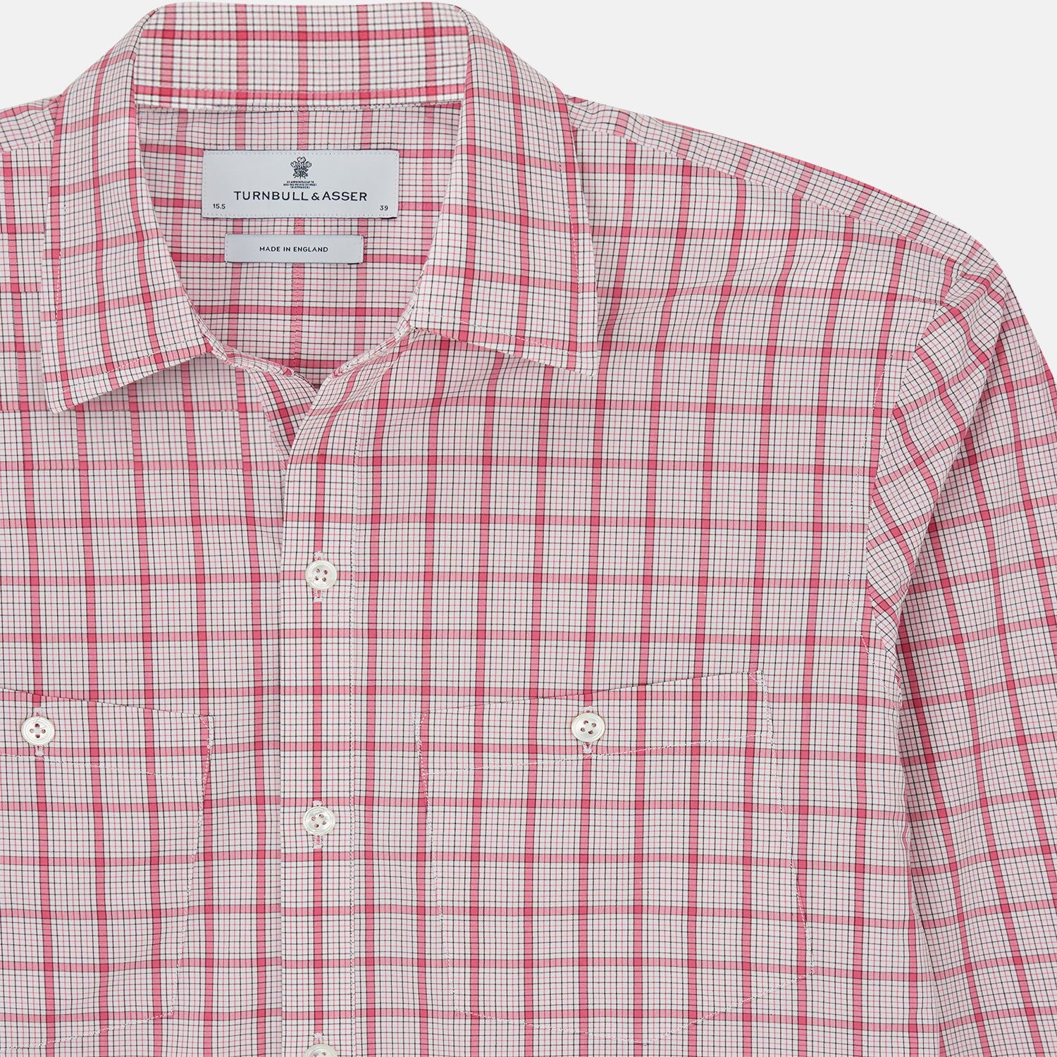 View 4 of product The Pink Graph Overlay Check Piccadilly Shirt by Turnbull & Asser features long sleeves, a button-up front, collar, and chest pockets—a stylish cotton option in a red and white check pattern for the holidays.
