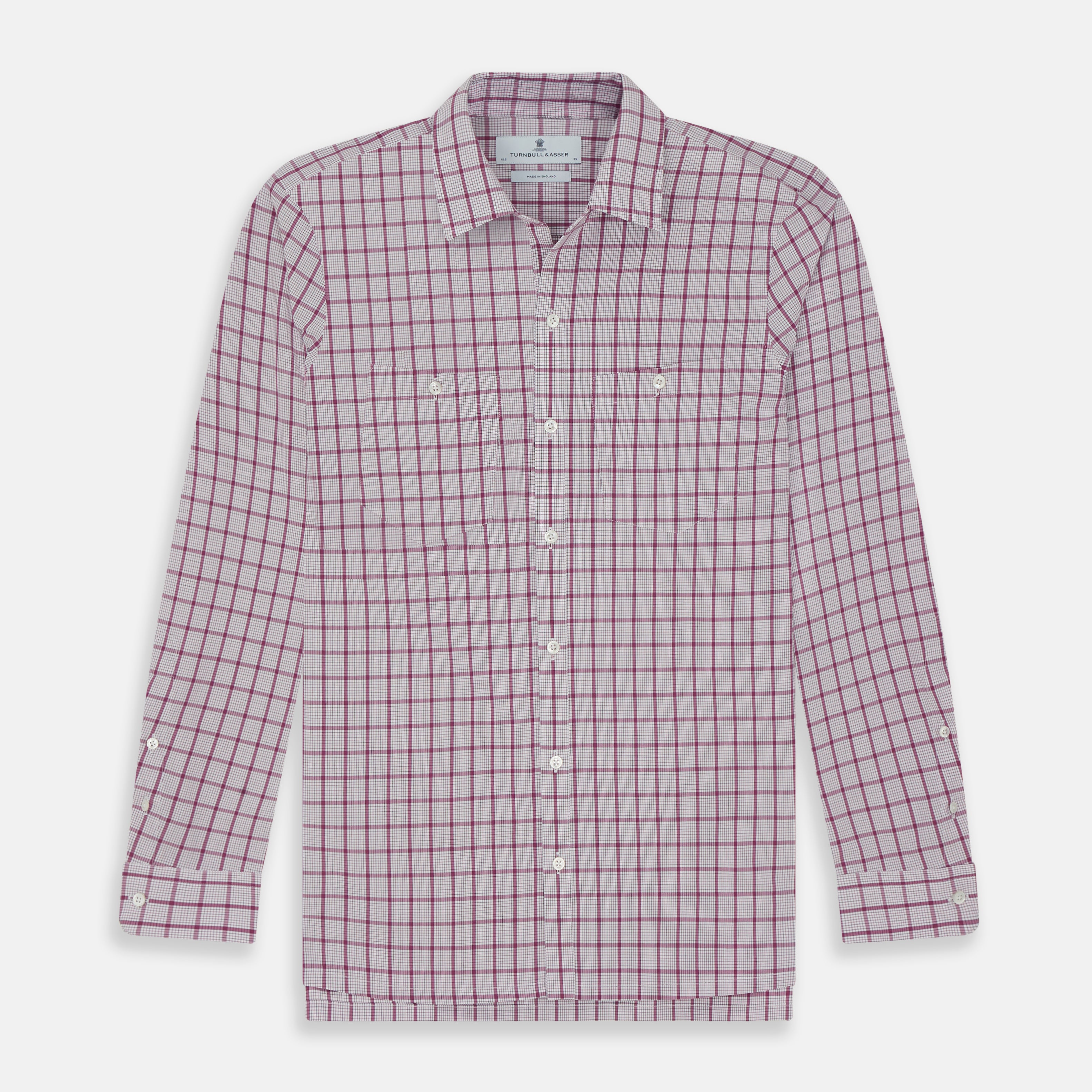 View 1 of product The Turnbull & Asser Purple Graph Overlay Check Piccadilly Shirt, a long-sleeve cotton button-up with two buttoned chest pockets, is neatly laid flat on a plain white background.
