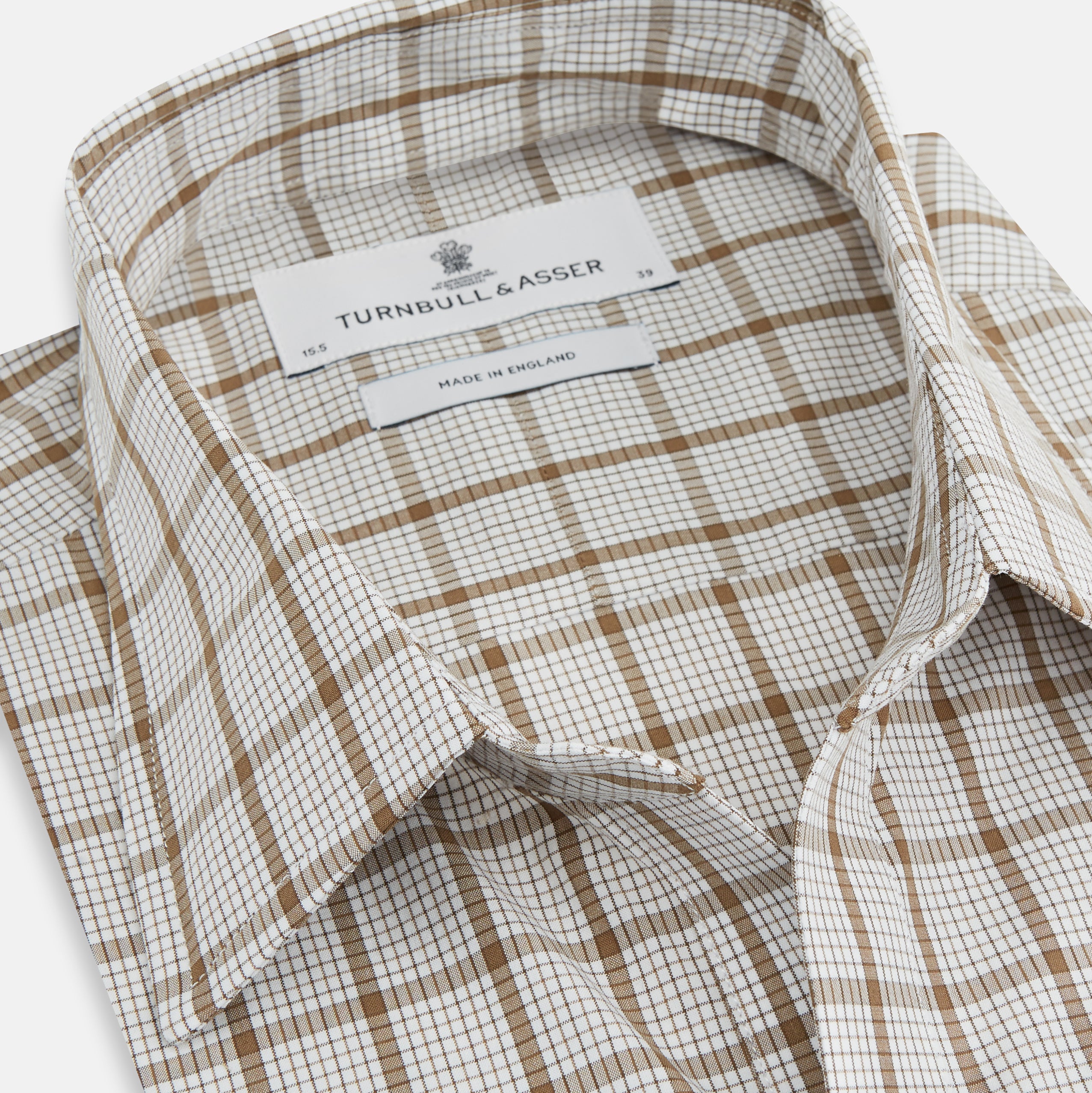 View 2 of product The Turnbull & Asser Brown Graph Overlay Check Piccadilly Shirt is a breathable cotton long-sleeve button-up with two chest pockets, in a beige and brown check pattern—ideal as your holiday fit shirt.