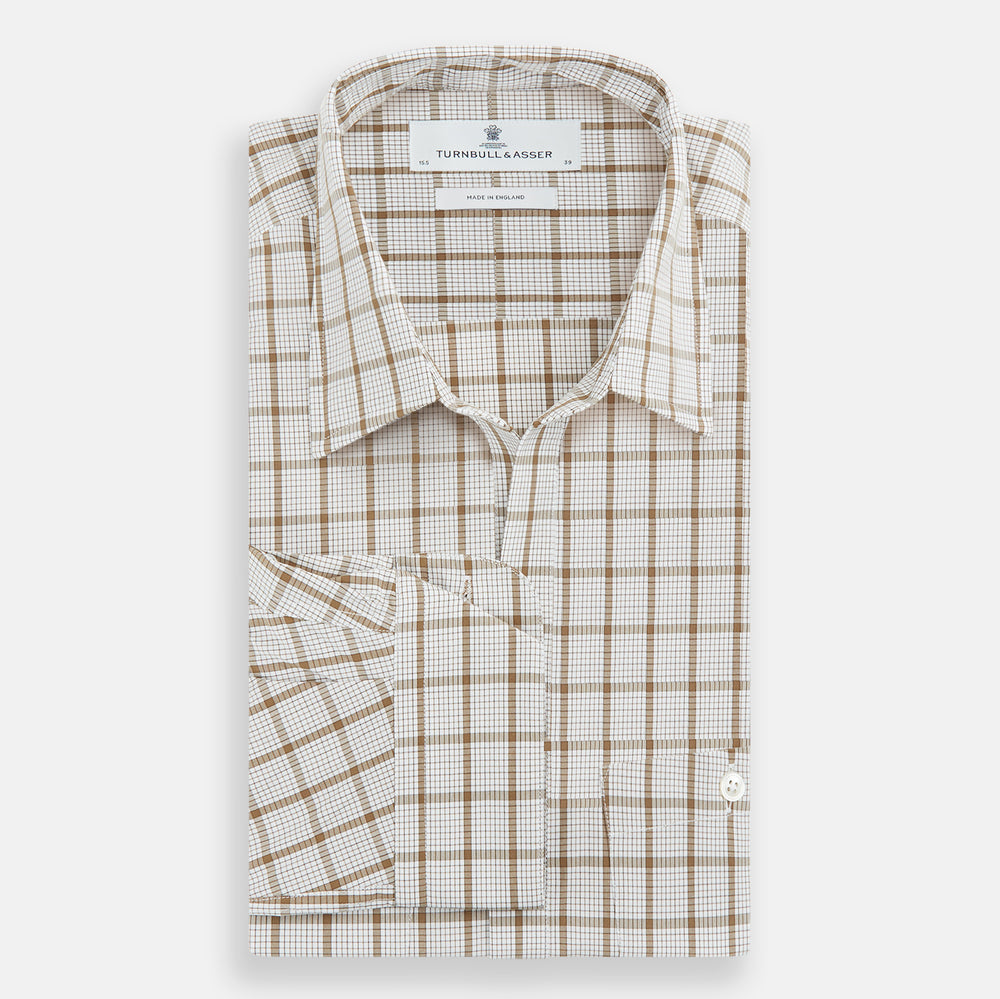 The Turnbull & Asser Brown Graph Overlay Check Piccadilly Shirt is a breathable cotton long-sleeve button-up with two chest pockets, in a beige and brown check pattern—ideal as your holiday fit shirt.