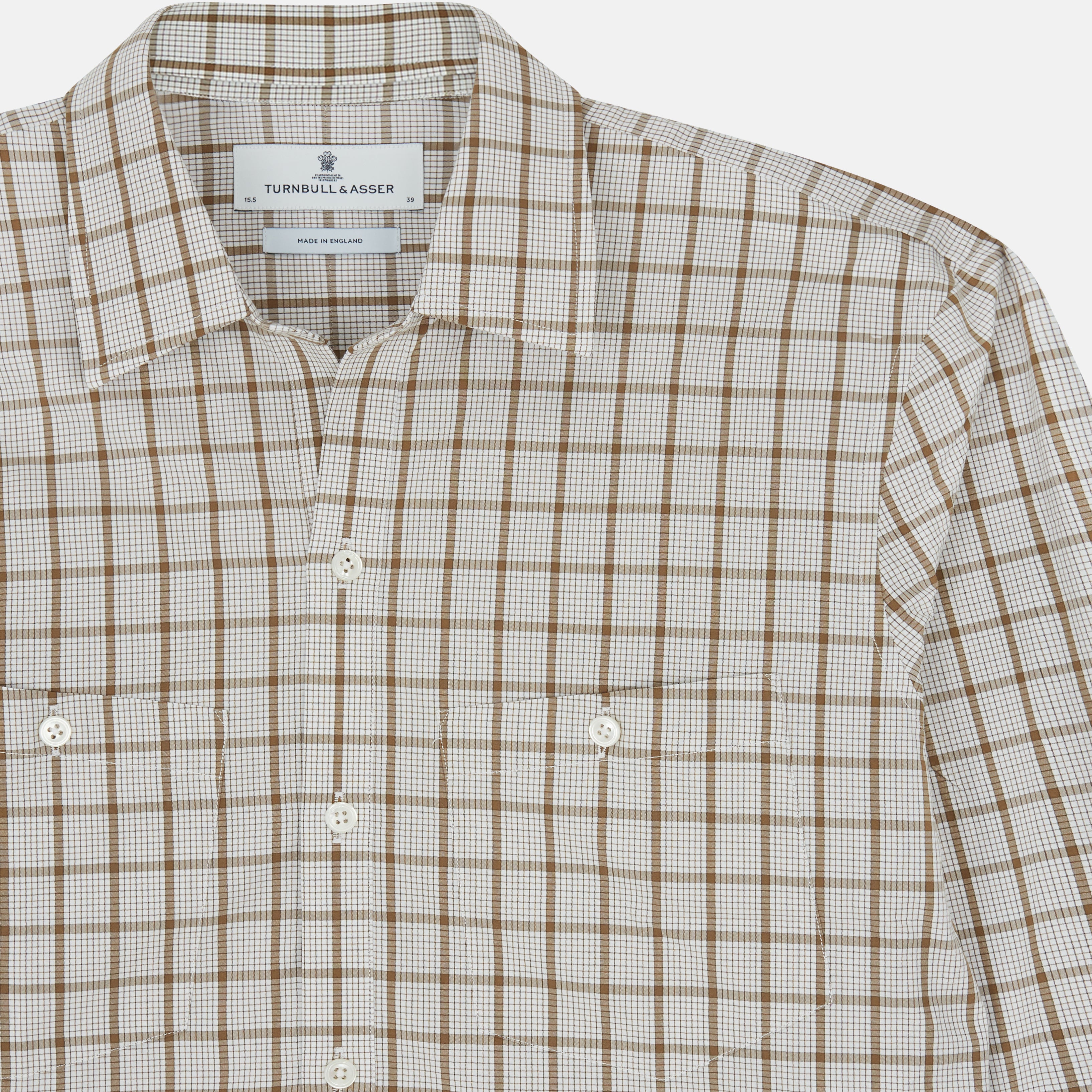 View 4 of product The Turnbull & Asser Brown Graph Overlay Check Piccadilly Shirt is a breathable cotton long-sleeve button-up with two chest pockets, in a beige and brown check pattern—ideal as your holiday fit shirt.