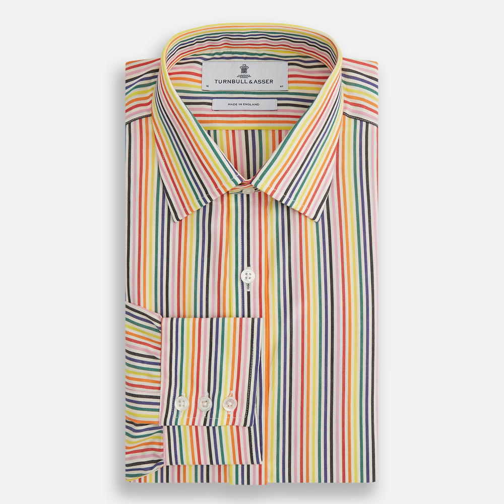 The MULTICOLOURED FELICIANO MAYFAIR SHIRT by Turnbull & Asser features vertical red, yellow, green, and blue stripes on white, a classic T&A collar, buttoned cuffs, and a rounded hem for timeless British style.