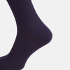 View 4 of product A single Dark Purple Mid-Length Merino Sock from Turnbull & Asser is shown upright on a plain white background, highlighting its ribbed texture.