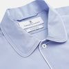 View 2 of product The Turnbull & Asser Blue Piped Sea Island Quality Cotton Nightshirt features light blue sea island cotton, a collared neckline with white piping, a front pocket, partial button placket, and a curved high-low hem for classic nightshirt style.