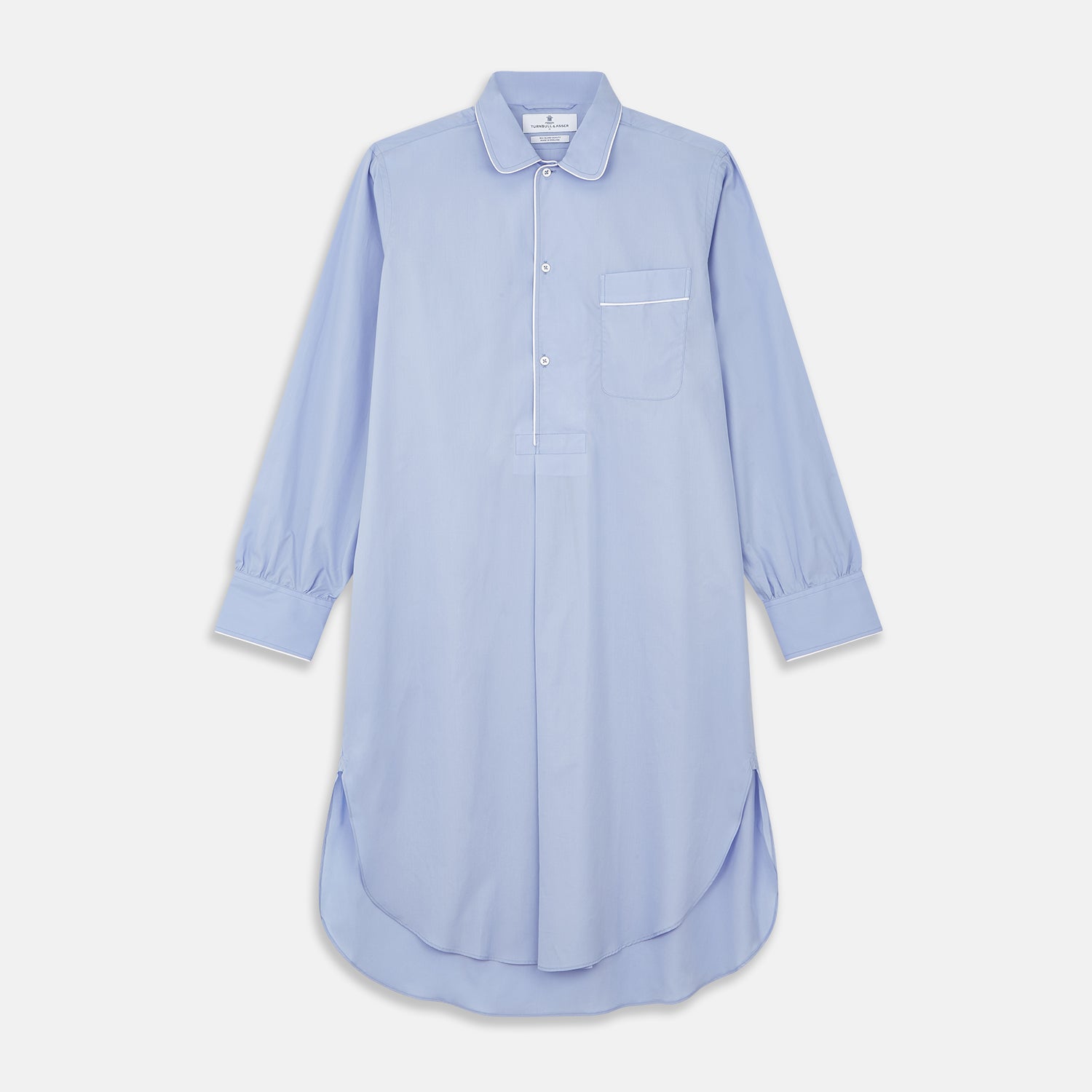 View 1 of product The Turnbull & Asser Blue Piped Sea Island Quality Cotton Nightshirt features light blue sea island cotton, a collared neckline with white piping, a front pocket, partial button placket, and a curved high-low hem for classic nightshirt style.