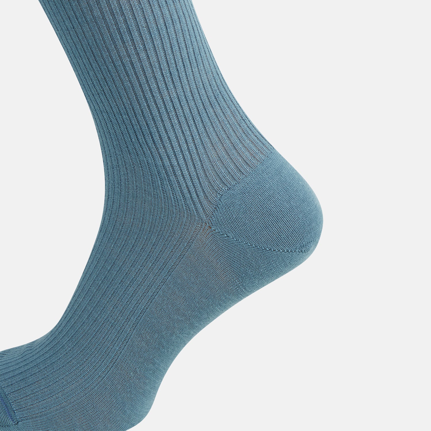 View 4 of product A single Pale Blue Mid-Length Merino Sock by Turnbull & Asser stands upright against a white background, highlighting its ribbed texture and reinforced toe and heel—showcasing the elegance of luxury merino wool.