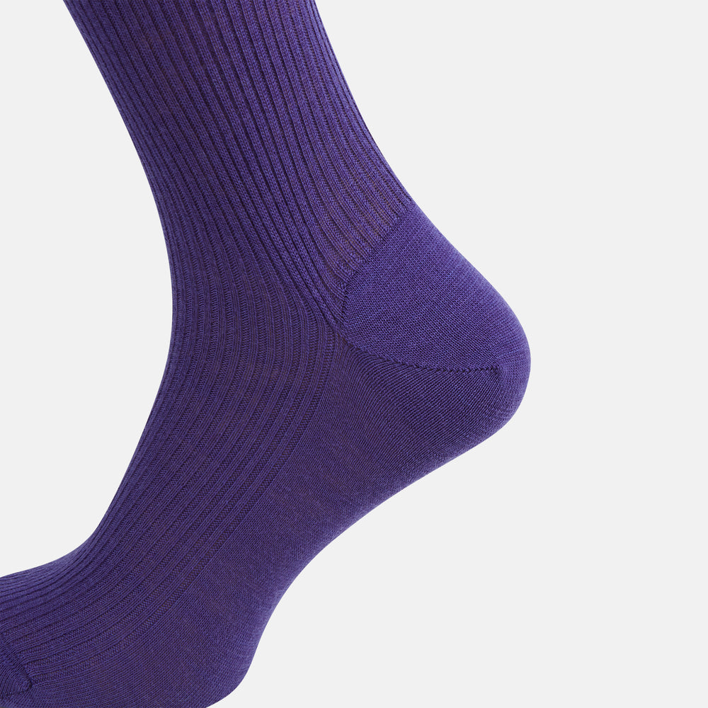 The Turnbull & Asser Violet Mid-Length Merino Socks, crafted from luxurious merino wool, feature a knee-high ribbed design and are shown upright against a plain white background.