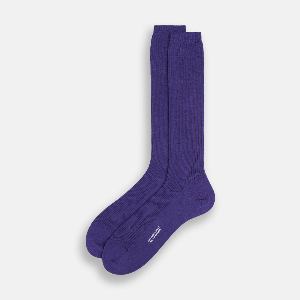 The Turnbull & Asser Violet Mid-Length Merino Socks, crafted from luxurious merino wool, feature a knee-high ribbed design and are shown upright against a plain white background.
