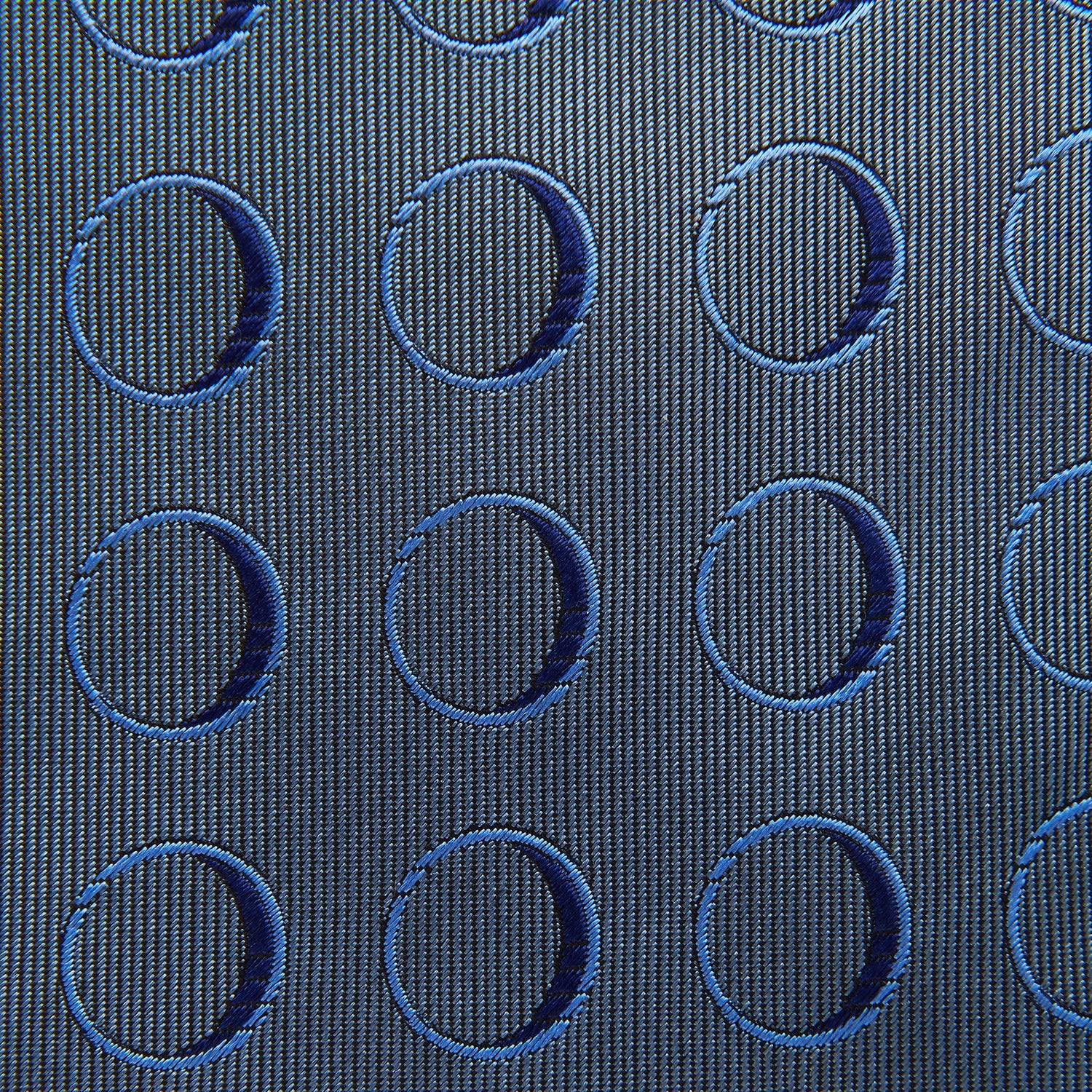 View 4 of product The Turnbull & Asser Die Another Day Circle Silk Tie, as seen on James Bond, features large dark blue ovals on a lighter blue background.