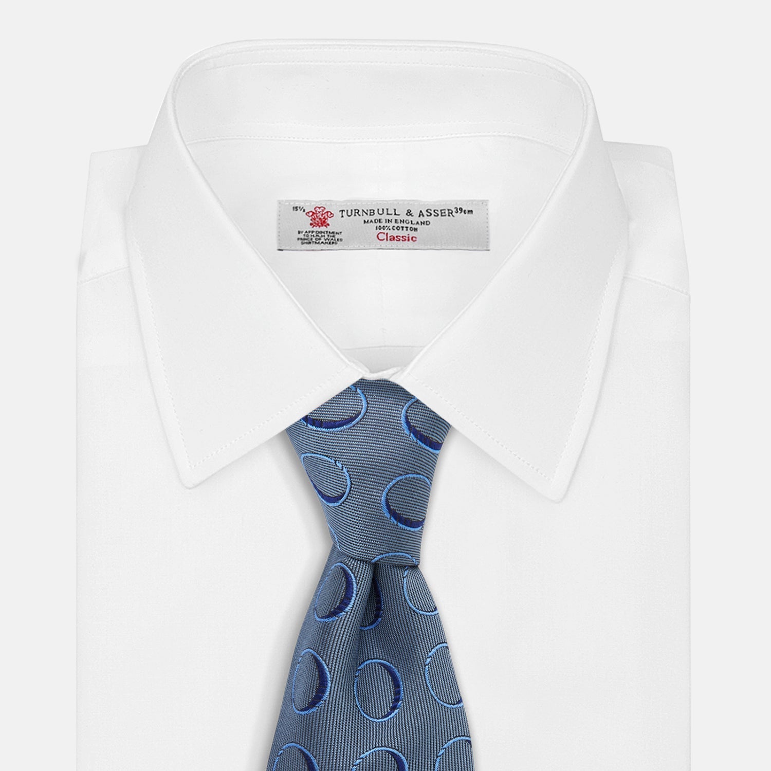 View 3 of product The Turnbull & Asser Die Another Day Circle Silk Tie, as seen on James Bond, features large dark blue ovals on a lighter blue background.
