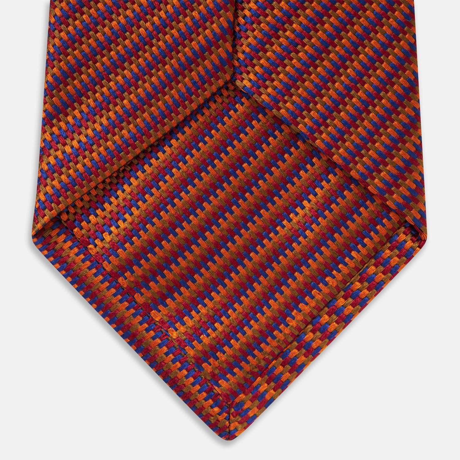 View 5 of product The Turnbull & Asser Die Another Day Stripe Silk Tie, as seen on James Bond, showcases a vibrant orange, red, and purple woven pattern, elegantly rolled and displayed against a white background.