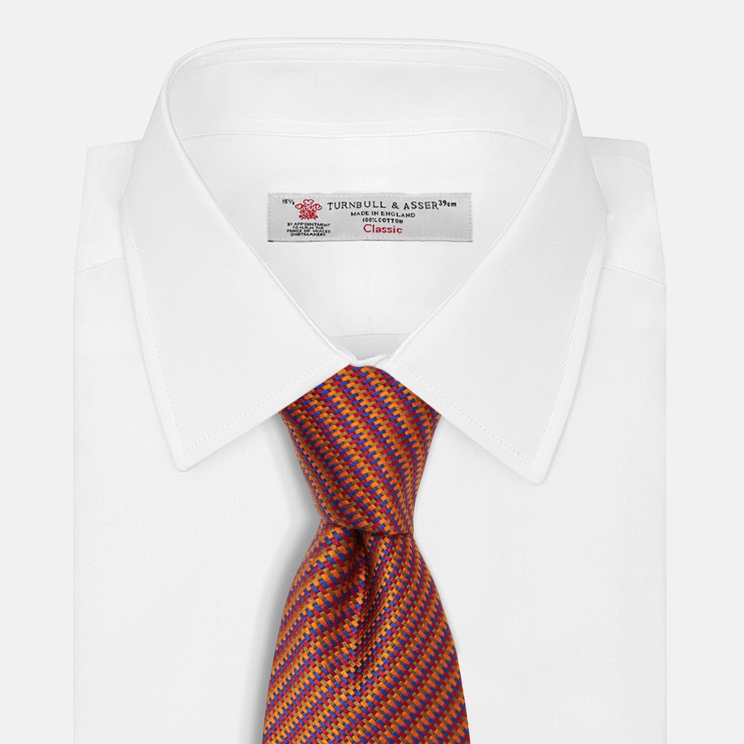View 2 of product The Turnbull & Asser Die Another Day Stripe Silk Tie, as seen on James Bond, showcases a vibrant orange, red, and purple woven pattern, elegantly rolled and displayed against a white background.