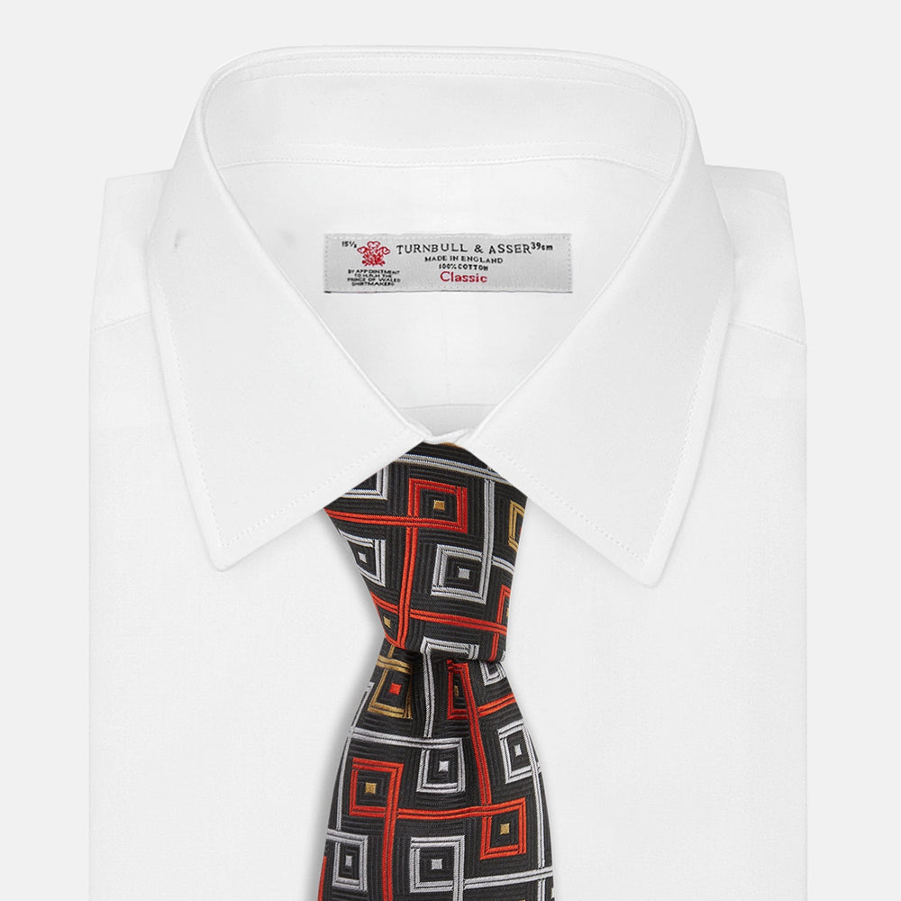 The Turnbull & Asser "The World Is Not Enough" Square Silk Tie, as seen on James Bond, features a geometric diamond pattern in black, red, yellow, and white on gray—an ideal stylish gift for any Bond fan.