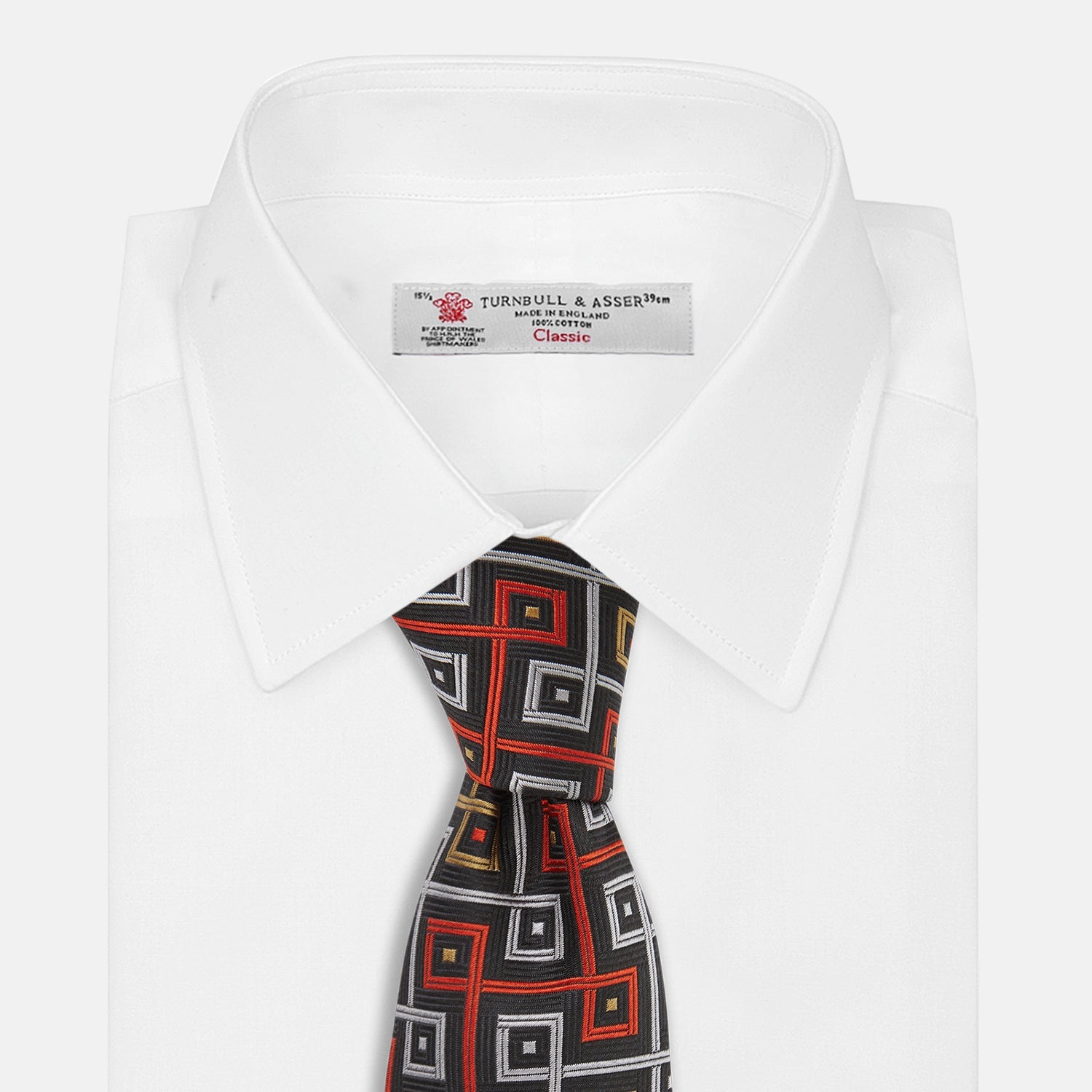 View 3 of product The Turnbull & Asser "The World Is Not Enough" Square Silk Tie, as seen on James Bond, features a geometric diamond pattern in black, red, yellow, and white on gray—an ideal stylish gift for any Bond fan.