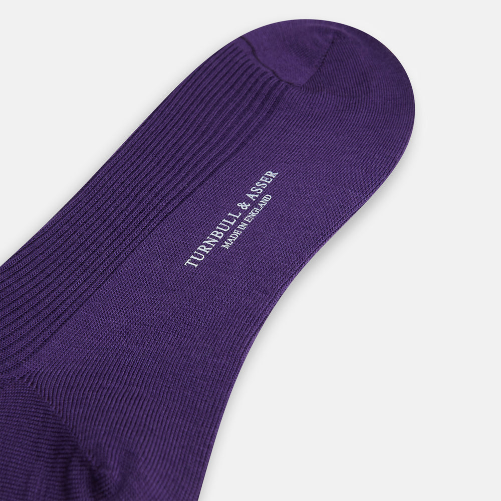 A single Turnbull & Asser Purple Mid-Length Merino Sock stands upright with the foot slightly raised against a plain white background.