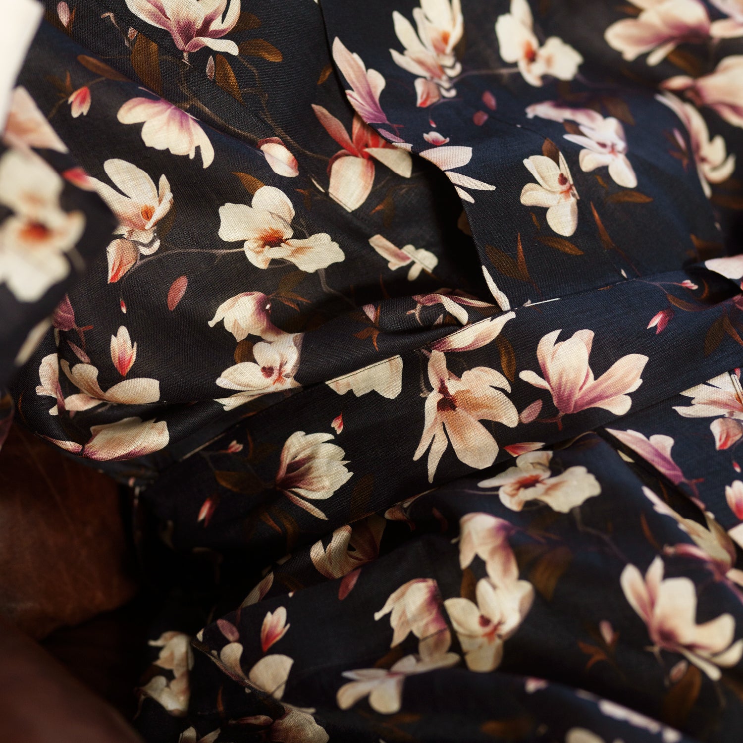 View 5 of product The Turnbull & Asser Navy Floral Pattern Linen Hayhurt Kimono Gown is a knee-length, long-sleeved gown with a floral print and a matching fabric belt tied at the waist.