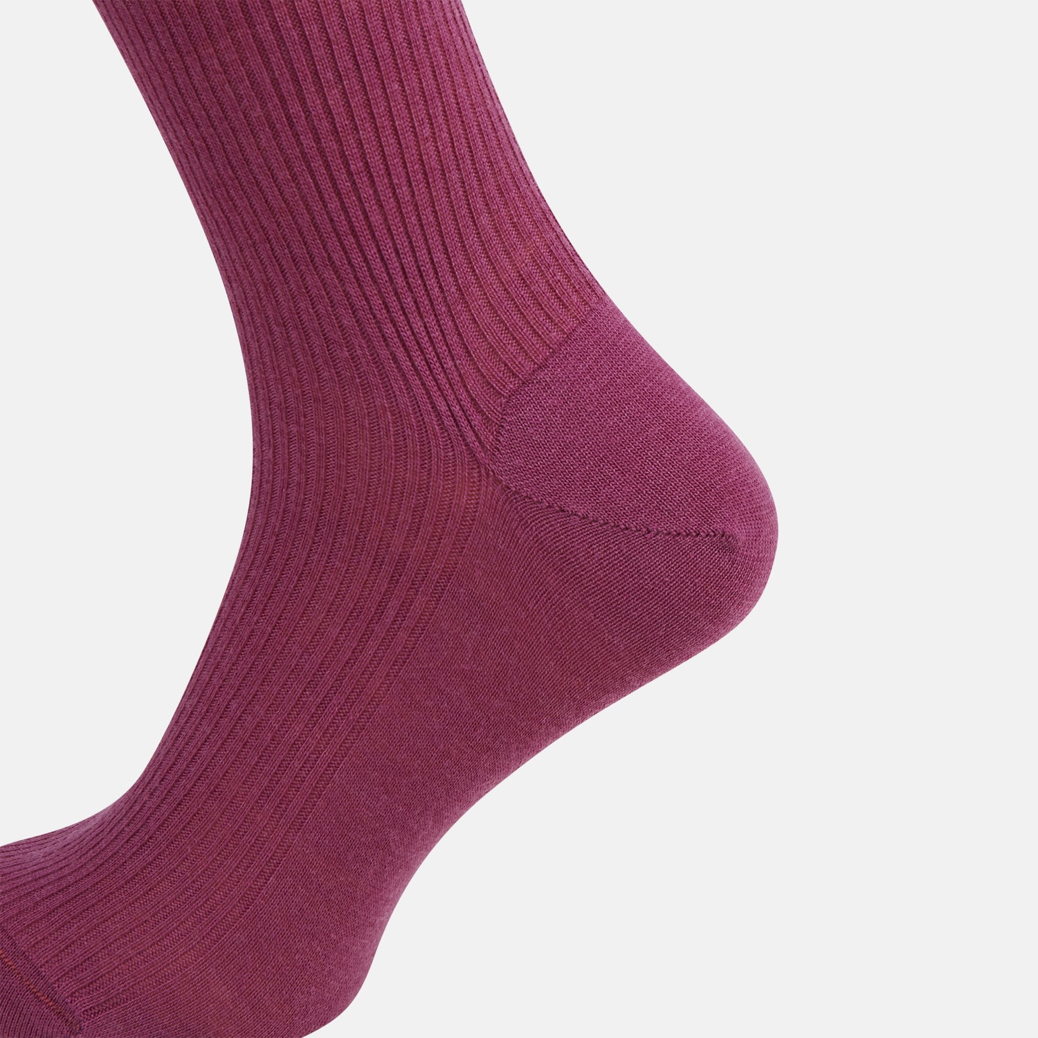 View 4 of product A single Turnbull & Asser Mauve Mid-Length Merino Sock is shown upright, foot angled downward, against a plain light gray background. The ribbed sock features a solid mauve color.