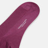 View 3 of product A single Turnbull & Asser Mauve Mid-Length Merino Sock is shown upright, foot angled downward, against a plain light gray background. The ribbed sock features a solid mauve color.