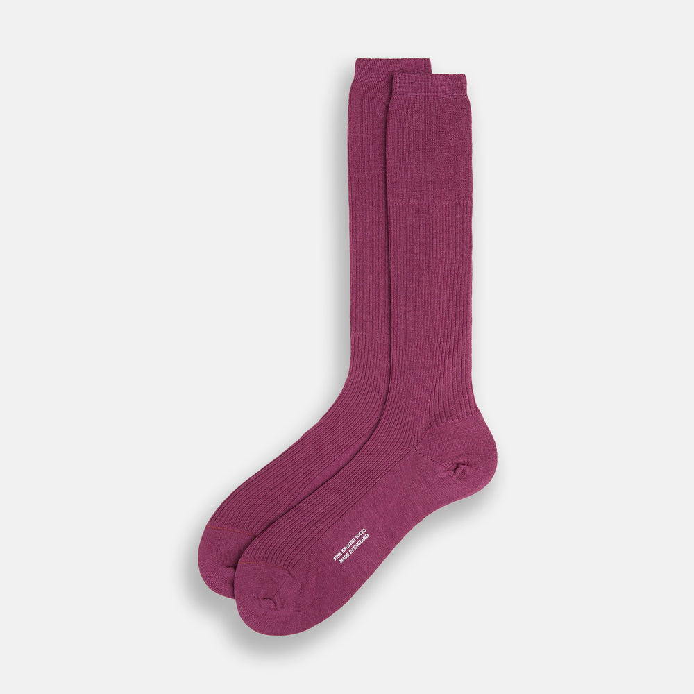 A single Turnbull & Asser Mauve Mid-Length Merino Sock is shown upright, foot angled downward, against a plain light gray background. The ribbed sock features a solid mauve color.