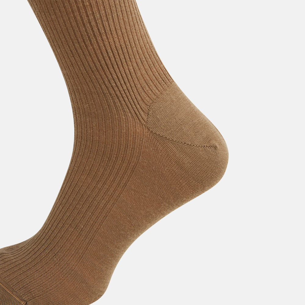 A single Turnbull & Asser Camel Mid-Length Merino Sock stands upright on a plain white background, showcasing its ribbed texture and reinforced toe and heel.
