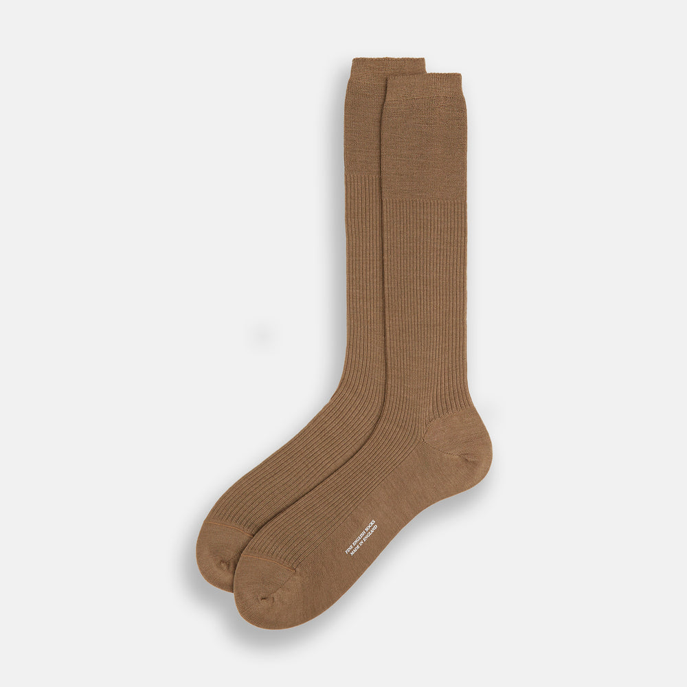 A single Turnbull & Asser Camel Mid-Length Merino Sock stands upright on a plain white background, showcasing its ribbed texture and reinforced toe and heel.