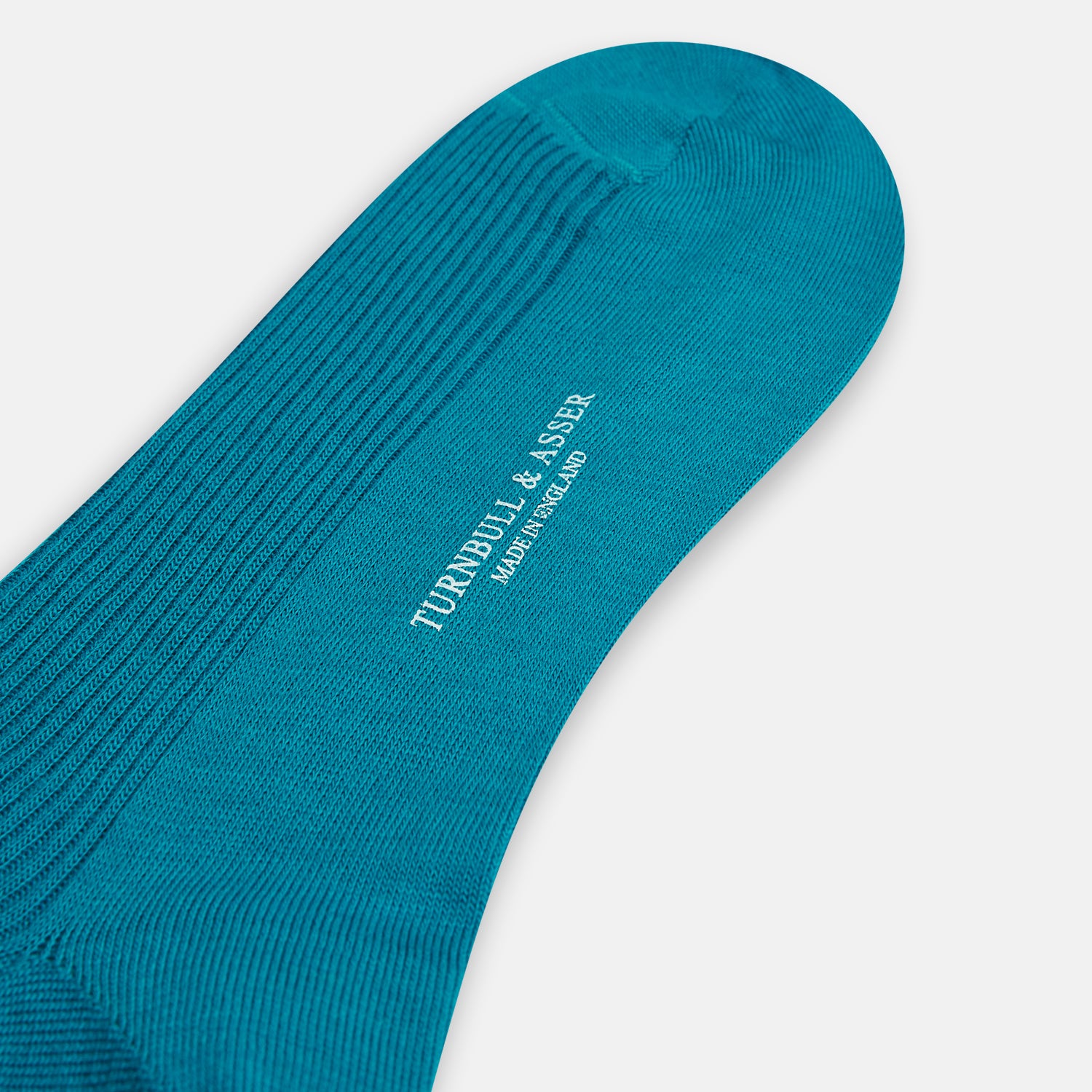 View 3 of product A Turnbull & Asser Turquoise Mid-Length Merino Sock stands upright on a plain light gray background, showcasing its ribbed texture and seamless toe.