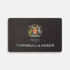 View 1 of product The Turnbull & Asser Gift Card (UK Only) is a black luxury card featuring a colorful royal crest, the words "By Appointment to His Majesty The King Shirtmakers," and "Turnbull & Asser" in bold white at the bottom.