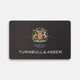 The Turnbull & Asser Gift Card (UK Only) is a black luxury card featuring a colorful royal crest, the words "By Appointment to His Majesty The King Shirtmakers," and "Turnbull & Asser" in bold white at the bottom.
