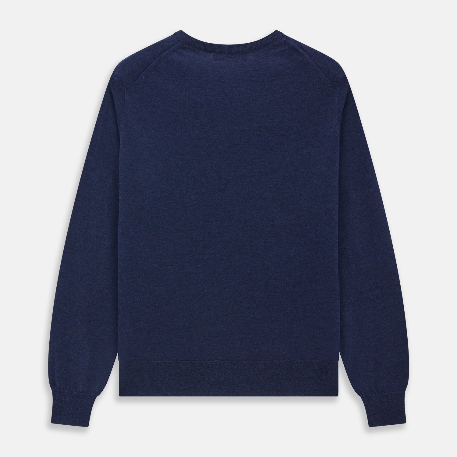 View 4 of product The Blue Crew Neck Merino Wool Jumper by Turnbull & Asser—a classic, long-sleeved staple with ribbed cuffs and hem—lies flat against a white background.