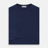 View 3 of product The Blue Crew Neck Merino Wool Jumper by Turnbull & Asser—a classic, long-sleeved staple with ribbed cuffs and hem—lies flat against a white background.