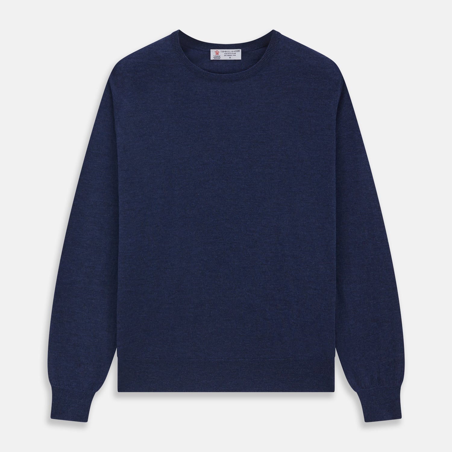 View 1 of product The Blue Crew Neck Merino Wool Jumper by Turnbull & Asser—a classic, long-sleeved staple with ribbed cuffs and hem—lies flat against a white background.