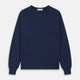 The Blue Crew Neck Merino Wool Jumper by Turnbull & Asser—a classic, long-sleeved staple with ribbed cuffs and hem—lies flat against a white background.