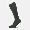 View 1 of product A single Fern Green Mid-Length Merino Sock by Turnbull & Asser, featuring a ribbed texture, is displayed on a plain white background at a slight angle to highlight its premium wool fabric, shape, and length.