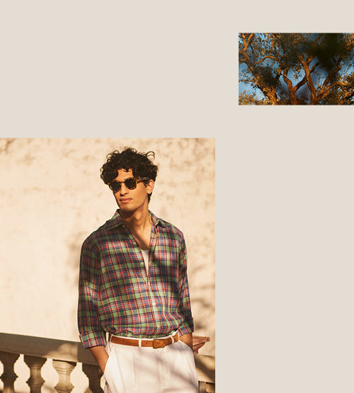 A man in sunglasses wears a plaid shirt tucked into white pants with a brown belt, standing by a stone railing. In the top right, there is a small photo of tree branches against the sky.
