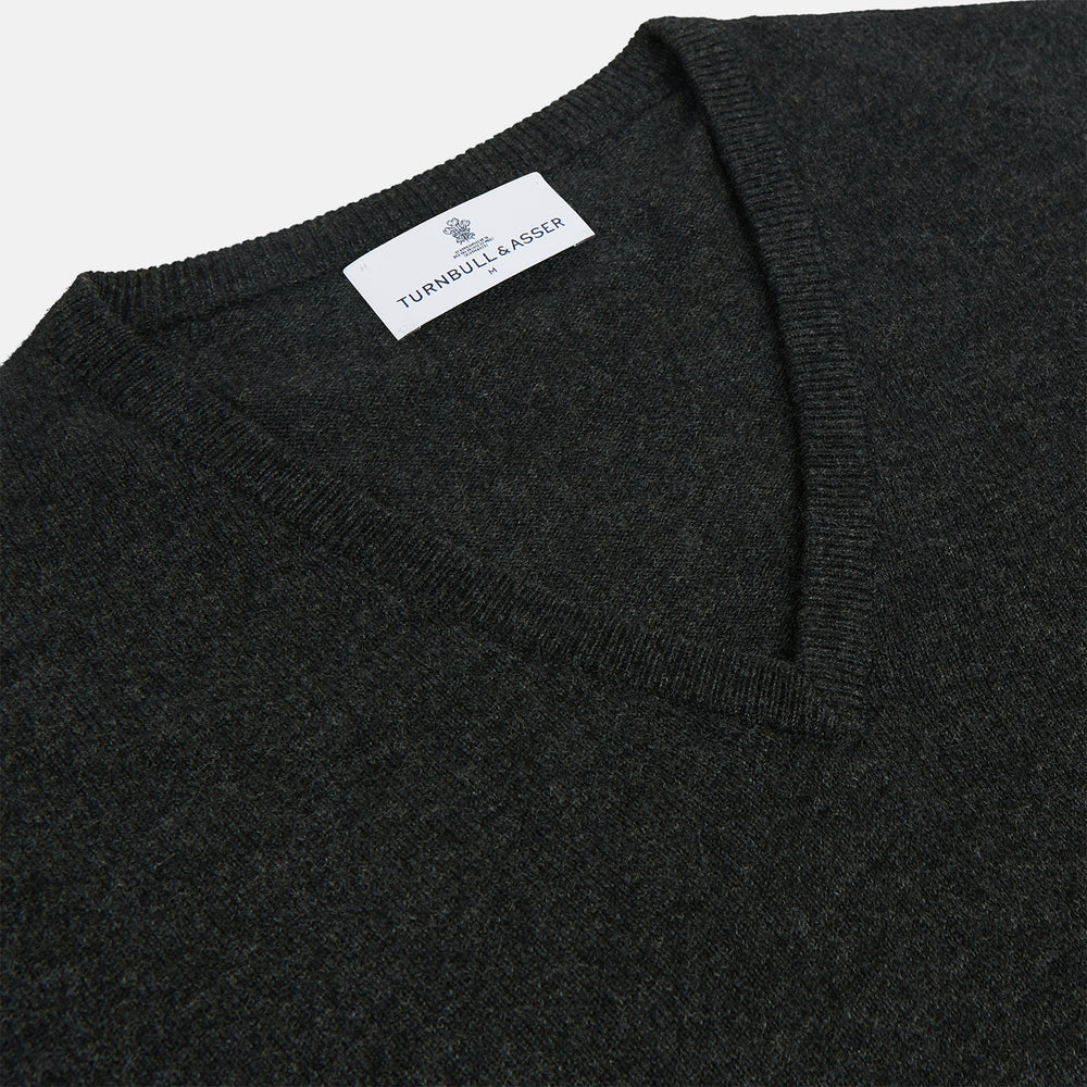 The Turnbull & Asser Charcoal V-Neck Cashmere Jumper, featuring long sleeves, is displayed flat on a white background.
