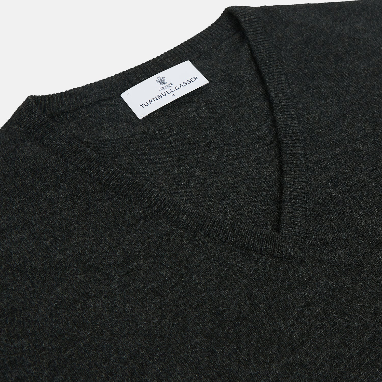 View 2 of product The Turnbull & Asser Charcoal V-Neck Cashmere Jumper, featuring long sleeves, is displayed flat on a white background.