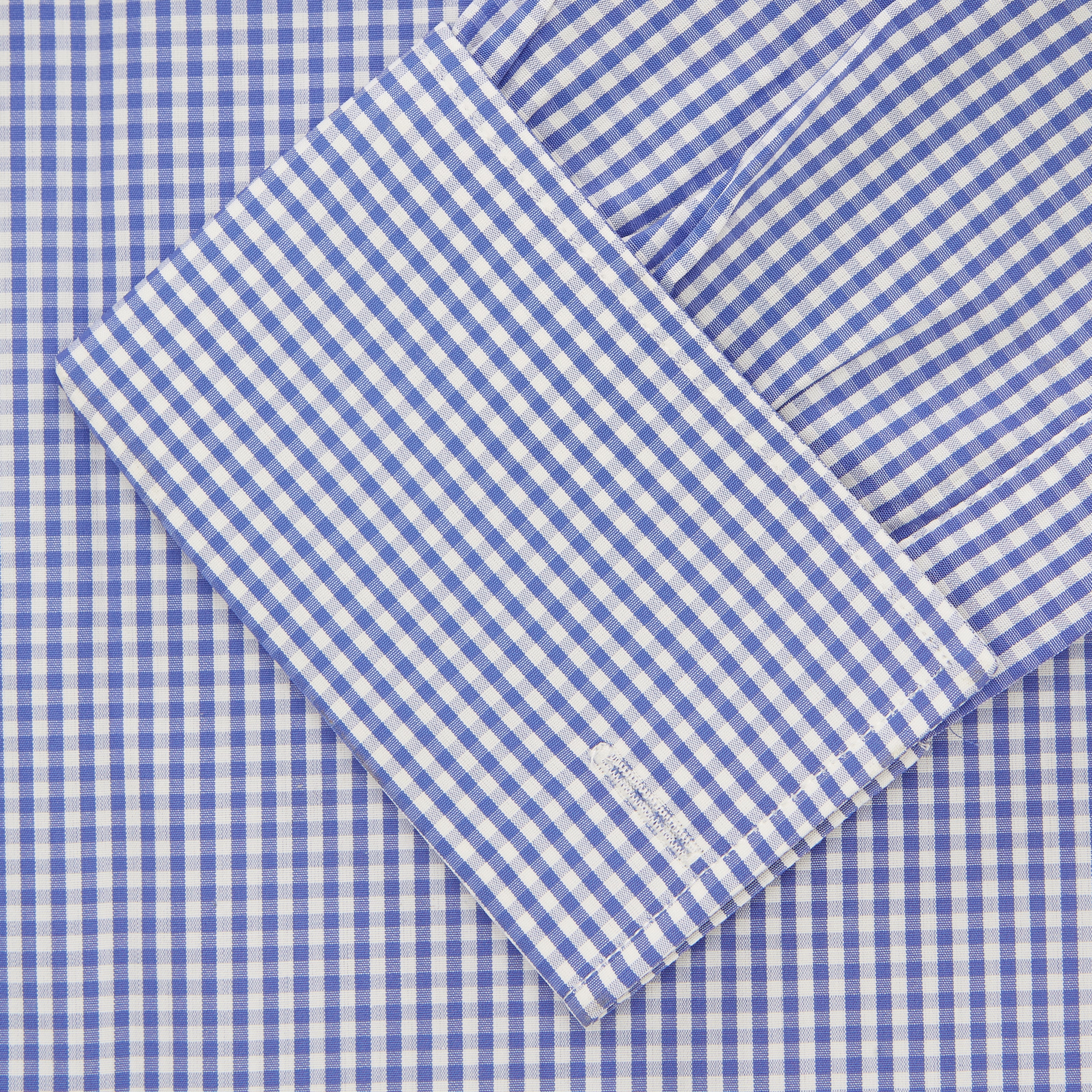 View 2 of product The Turnbull & Asser Mid Blue Gingham Check Shirt features a T&A collar, double cuffs, and white buttons, neatly displayed against a plain white background.