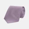 View 1 of product The Turnbull & Asser Lilac Houndstooth Silk Tie features a subtle houndstooth pattern and elegant silk weave—ideal for elevating your favorite office shirt. Displayed rolled on a white background.