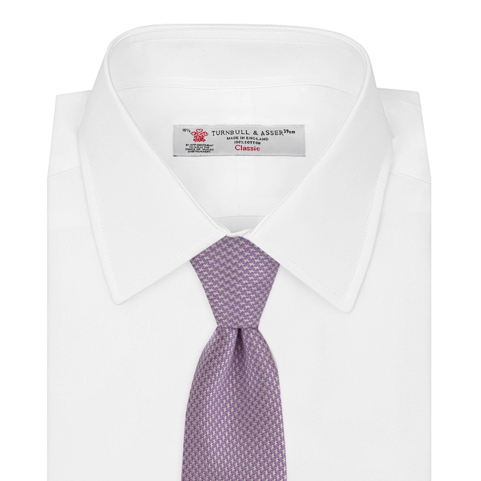 View 2 of product The Turnbull & Asser Lilac Houndstooth Silk Tie features a subtle houndstooth pattern and elegant silk weave—ideal for elevating your favorite office shirt. Displayed rolled on a white background.