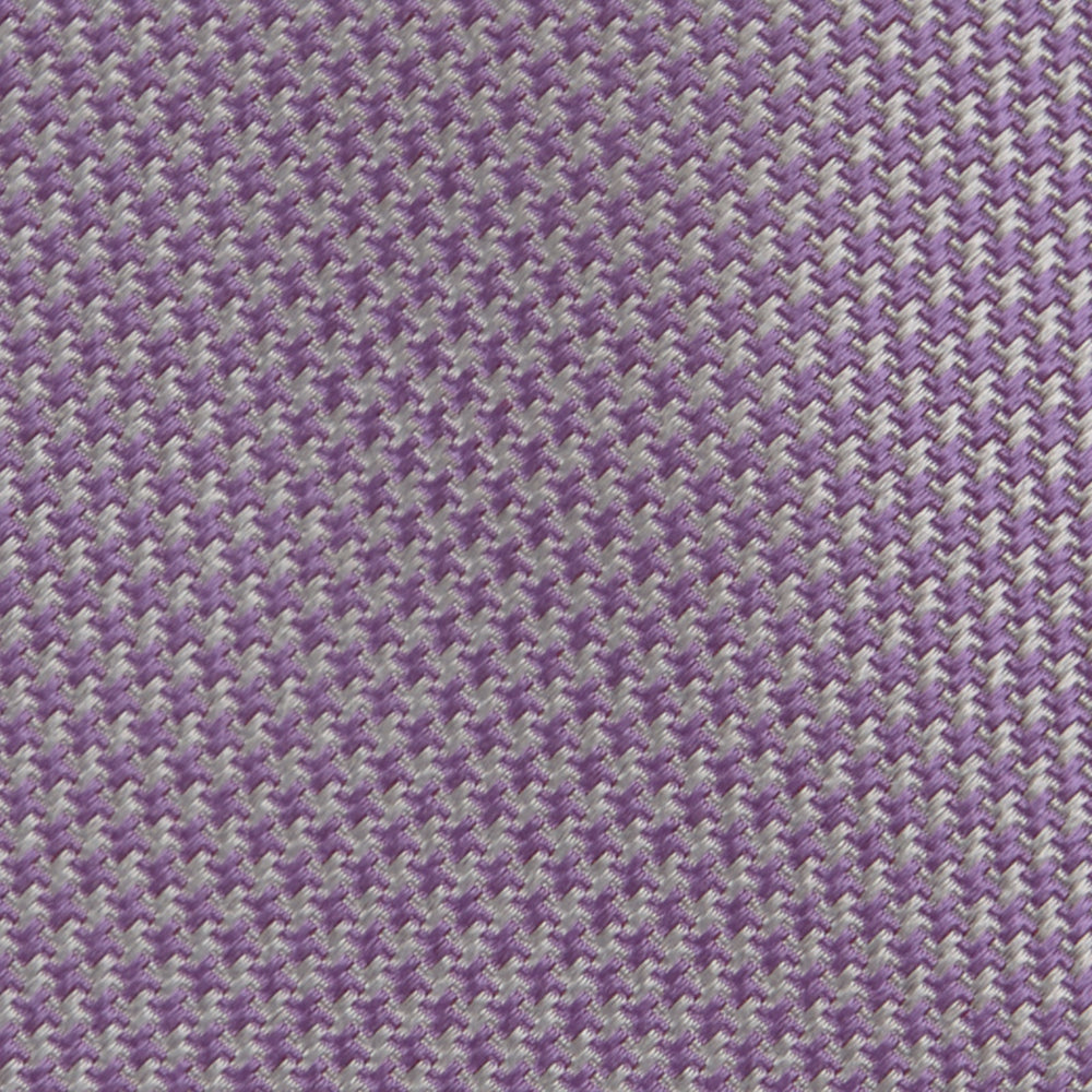 The Turnbull & Asser Lilac Houndstooth Silk Tie features a subtle houndstooth pattern and elegant silk weave—ideal for elevating your favorite office shirt. Displayed rolled on a white background.
