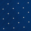 View 3 of product The Turnbull & Asser Royal Blue and White Small Spot Herringbone Silk Tie is displayed rolled at one end on a plain white background, showcasing its classic English silk design with subtle white polka dots.