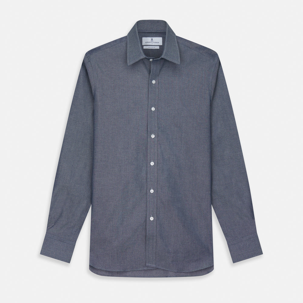 The Turnbull & Asser Plain Blue Oxford Weekend Fit Shirt features a Derby collar, 1-button cuffs, and a smart-casual look—perfect for weekends. Displayed flat on a white background.