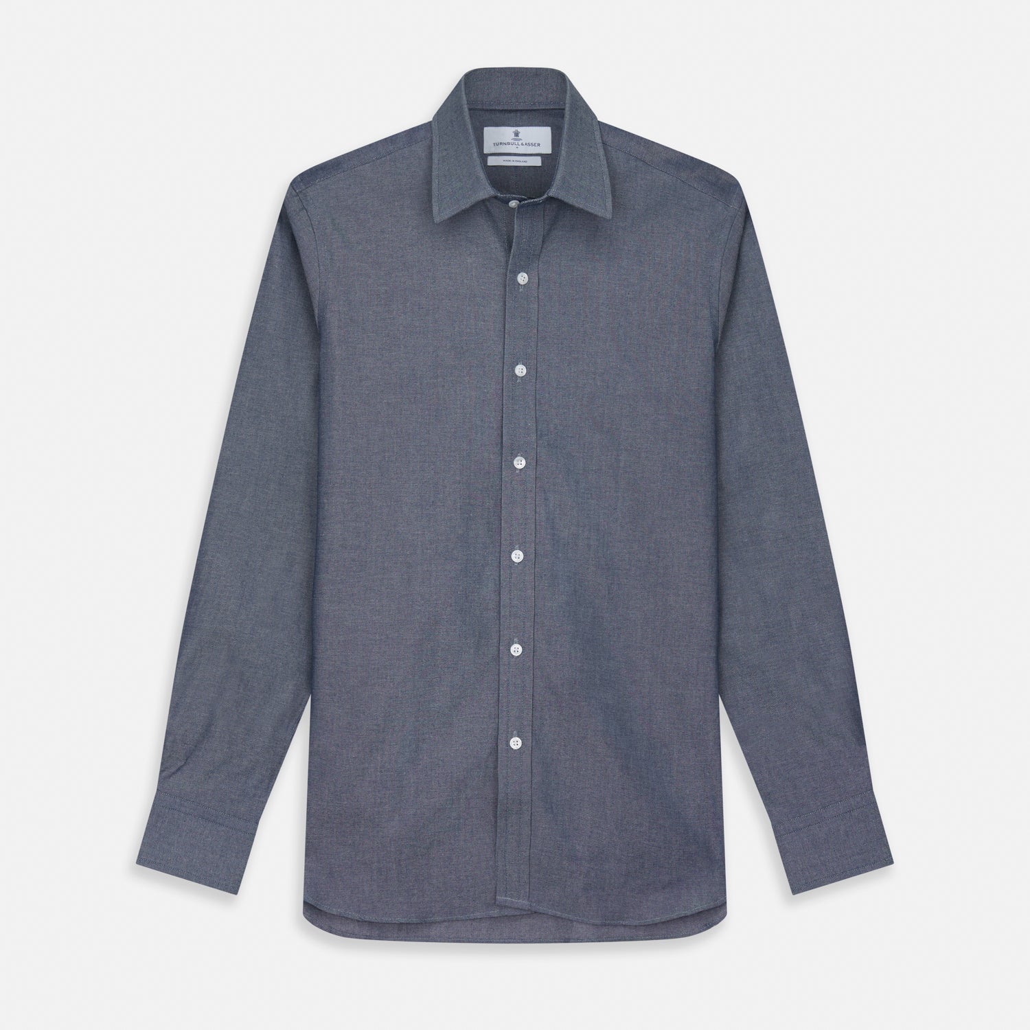 View 1 of product The Turnbull & Asser Plain Blue Oxford Weekend Fit Shirt features a Derby collar, 1-button cuffs, and a smart-casual look—perfect for weekends. Displayed flat on a white background.