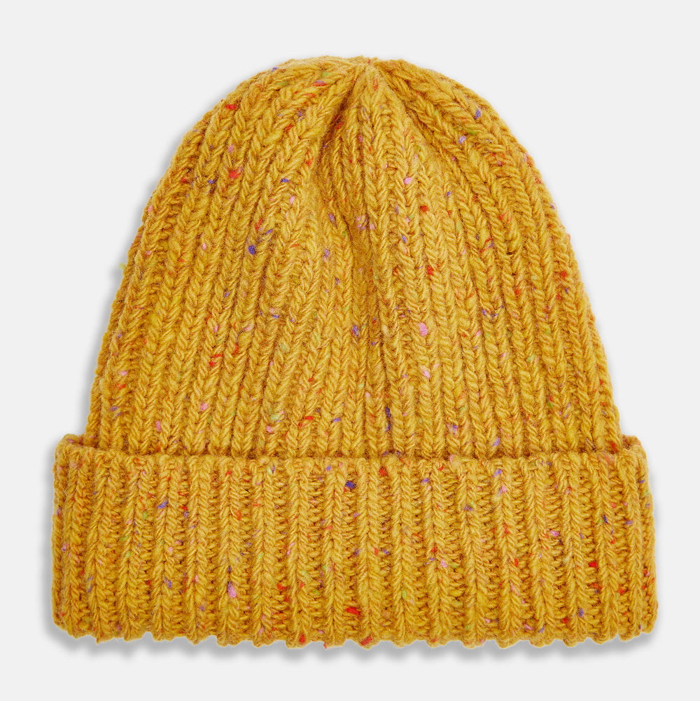The Turnbull & Asser Yellow Donegal Ribbed Merino Hat features a mustard hue, folded brim, and subtle multicolored flecks in the yarn. Shown on a white background.
