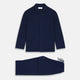 The Turnbull & Asser Navy Cashmere Knitted Traditional Pyjama Set features a long-sleeve camp collar shirt with front pockets and matching drawstring pants, offering an elevated twist on classic loungewear.