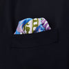 View 3 of product The Turnbull & Asser Green Multi Griffins Silk Pocket Square features blue mythical griffins at the center and decorative pink, gold, and blue borders—an ideal accessory for autumn ensembles.