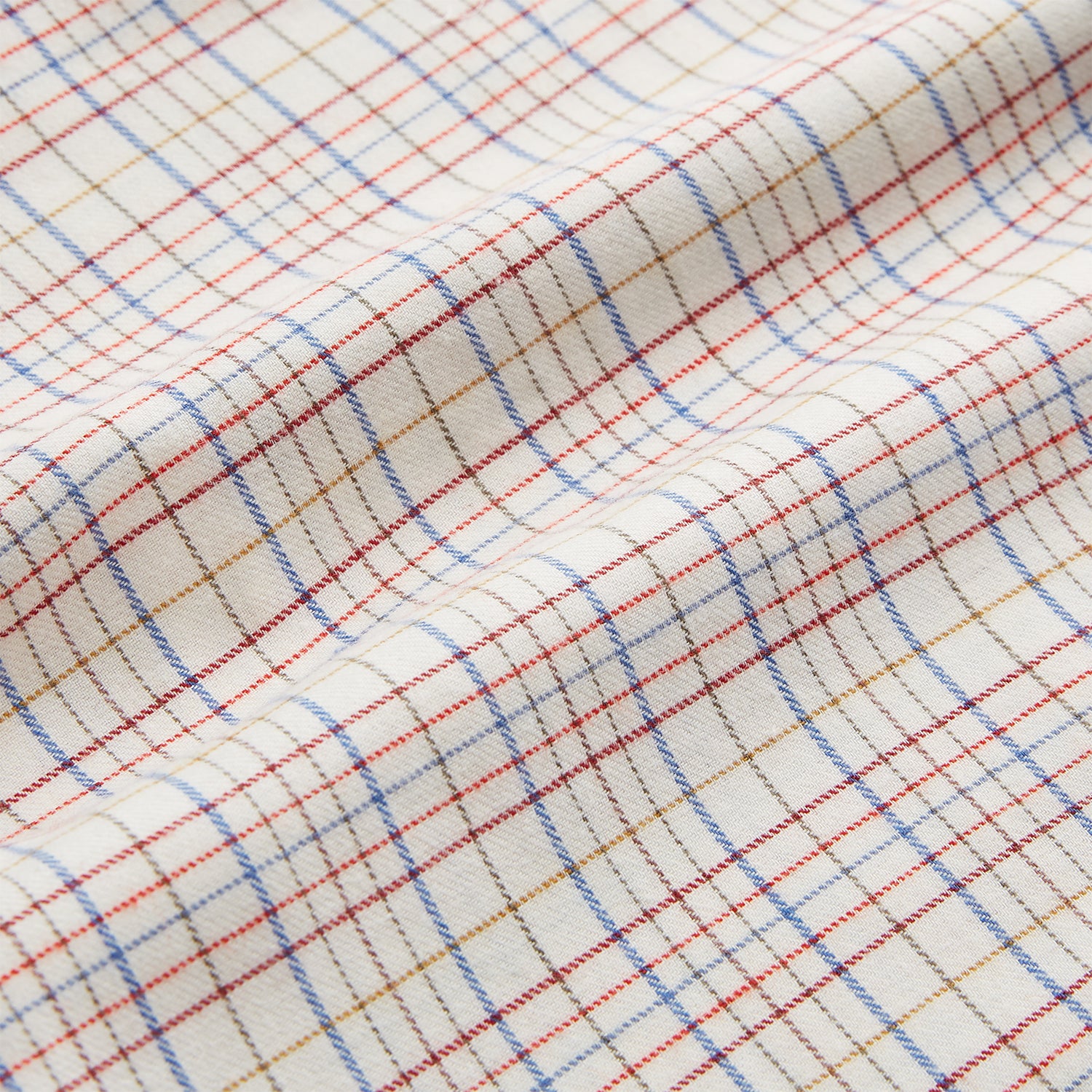 View 4 of product The Turnbull & Asser Red Multi Check Regular Fit Cotton-Cashmere Shirt features a T&A collar, 3 button cuffs, and a multicolored check pattern on white, shown laid flat against a white surface.